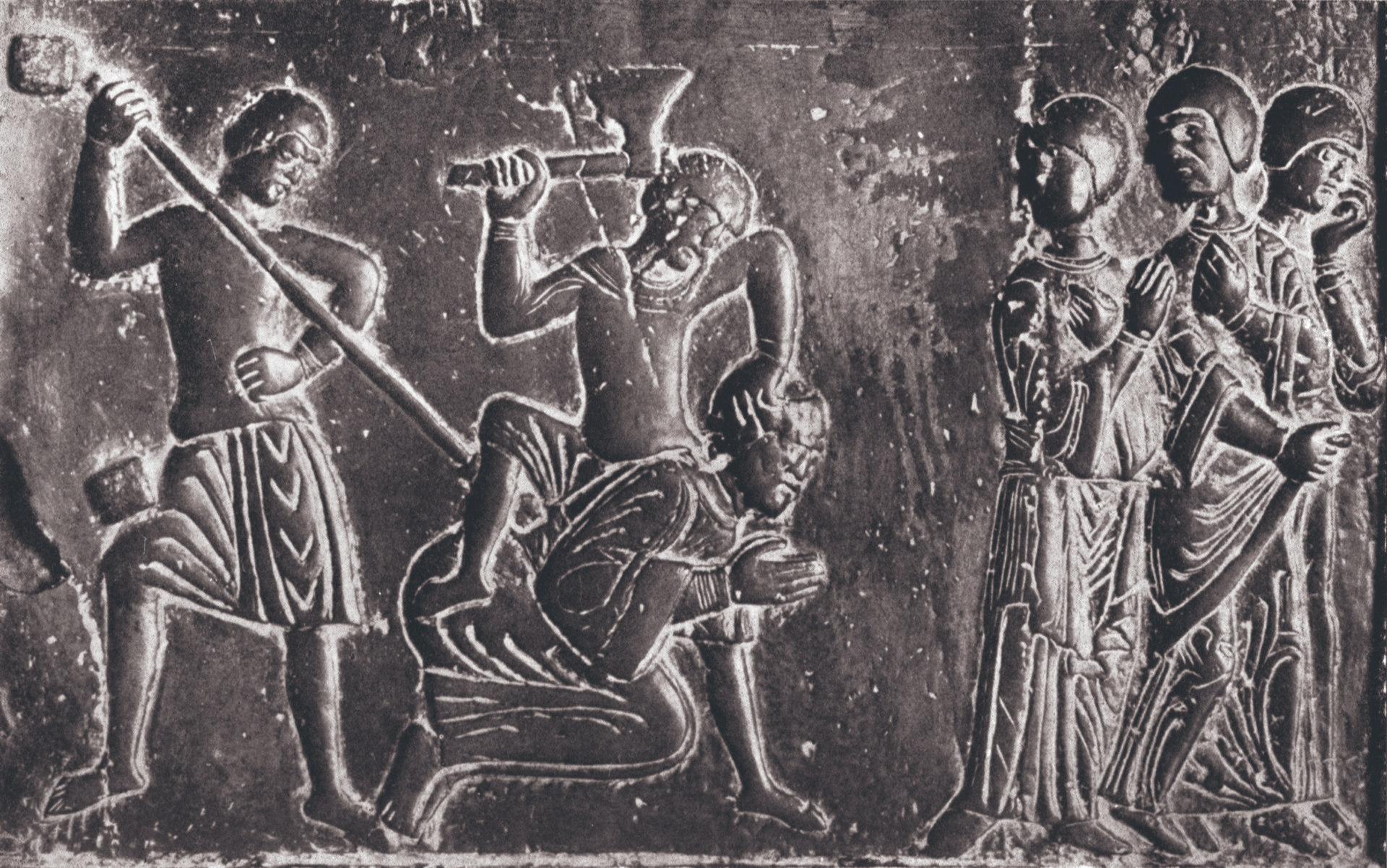Die noch heidnischen Prußen töten Vojtěc, den überaus frommen Sohn des böhmischen Fürsten, der sich die Christianisierung der Prußen zum Ziel gesetzt hatte: Darstellung auf der Gnesener Bronzetür aus dem 12. Jahrhundert